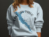 Light blue crewneck sweatshirt with Lake San Pablo California map and compass design.