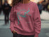 Pink sweatshirt with "Lake Allatoona Georgia" and compass graphic.