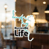 Burnsville Life sticker with a turquoise outline of a lake over black text.