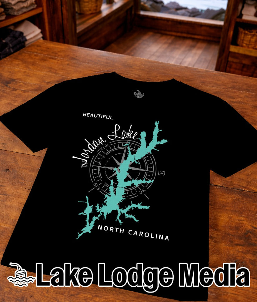 Black t-shirt with Jordan Lake map outline, compass, and "Lake Lodge Media" logo.
