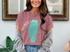Pink t-shirt with "Black Lake" text and turquoise lake shape graphic.