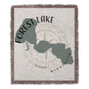 Woven blanket with Forest Lake map and Minnesota text over compass design.