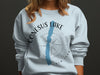 Light blue sweatshirt with "Conesus Lake New York" and compass design.