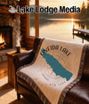 Oneida Lake map and compass design on a throw blanket draped over a leather couch.