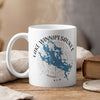 White mug with blue Lake Winnipesaukee map and compass design, text "New Hampshire".
