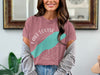 Rose t-shirt with "Lake Louise" graphic and compass rose design over a turquoise shape.