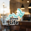 Turquoise lake outline sticker with "James Life" text on glass.