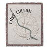 Woven blanket with Lake Chelan and compass rose design, "Lake Chelan Washington" text.