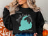 Black sweatshirt with "Merrill Creek Reservoir NEW JERSEY" text and map outline.