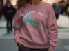 Pink crewneck sweatshirt with Pokegama Lake, Minnesota graphic and compass rose.