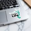 Sticker with "Houston Life" text and a teal outline of Texas overlaying a laptop.