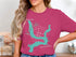 "Kaw Lake Oklahoma" text on a teal map outline on a magenta t-shirt.