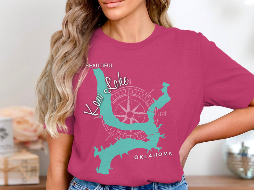 "Kaw Lake Oklahoma" text on a teal map outline on a magenta t-shirt.