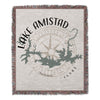 Woven blanket with Lake Amistad map, compass rose, and text.