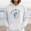 White hoodie with Minong Flo Nage Wisconsin compass and map design.