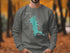 Grey sweatshirt with turquoise Lynx Lake, Arizona map graphic and compass rose.