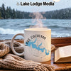 White mug with "Lake Cachuma California" design, steaming, by a rainy window.