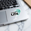 Charleston Life sticker featuring a teal map shape over a laptop keyboard.