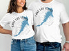 Men's and women's white t-shirts with Lake Las Vegas map and compass design.