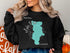 Black sweatshirt with "Lake Piru CALIFORNIA" and a teal map outline.