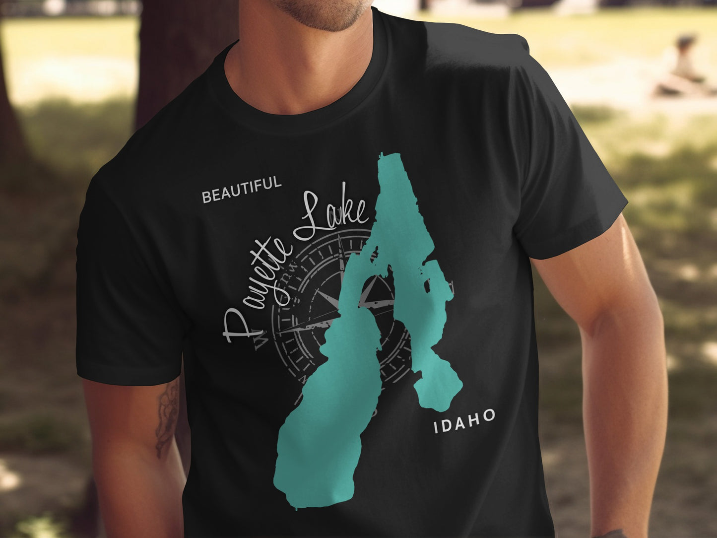 Black t-shirt with teal outline of Payette Lake and compass rose.