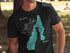 Black t-shirt with teal outline of Payette Lake and compass rose.