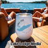 A white stemless wine tumbler with Lake Erie branding sits on a boat table.
