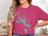 Pink t-shirt with a teal Jordan Lake map and compass graphic, reading "Beautiful Jordan Lake Alabama".
