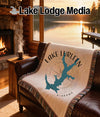 Tapestry throw with Lake Lurleen, Alabama map design on a leather couch.