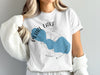 White t-shirt with Pearl Lake Wisconsin map graphic and compass.