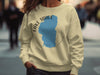Light yellow sweatshirt with "Lake Tahoe California" text and blue lake outline graphic.