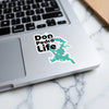 Don Pedro Life sticker with teal map shape on a laptop keyboard.