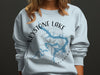 Light blue sweatshirt with Keystone Lake Oklahoma map and compass design.