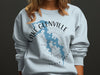 Light blue sweatshirt with Lake Glenville, North Carolina map and compass graphic.