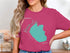 Pink t-shirt with turquoise silhouette of Hauser Lake, Idaho.