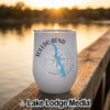 A white tumbler with a Toledo Bend Louisiana map graphic rests on a wooden dock at sunset.