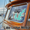 Teal Lake Life sticker on a boat window with Lake Lodge Media text.