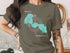 Turquoise Forest Lake map graphic on a dark olive t-shirt.