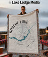 Man holds Apache Lake, Arizona map blanket with compass rose design.