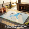 Custom glass cutting board with Lakewood Lakes Missouri map design on a wooden outdoor bar.