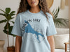 Light blue t-shirt with a blue Canyon Lake map outline and compass rose graphic.