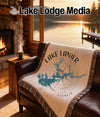 Fringe blanket with Lake Lanier map and compass design on a leather couch.