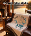 Woven blanket with Lake Texoma map and compass design on brown leather couch.