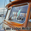 Champlain Life sticker on a boat window and Lake Lodge Media logo.