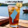 Glass of iced tea with blue lake silhouette and lemon slice.