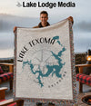 Woven blanket with Lake Texoma map and compass design, held by a smiling man.