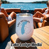 A white insulated tumbler featuring Lake Michigan and compass graphics sits on a boat table.