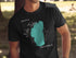 Black t-shirt featuring a teal silhouette of Lake Tahoe and text.