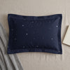Dark pillowcase with all-over light blue snowflake pattern and decorative stitching.