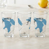 Three clear glasses with blue Lake Huron maps and compass rose designs.